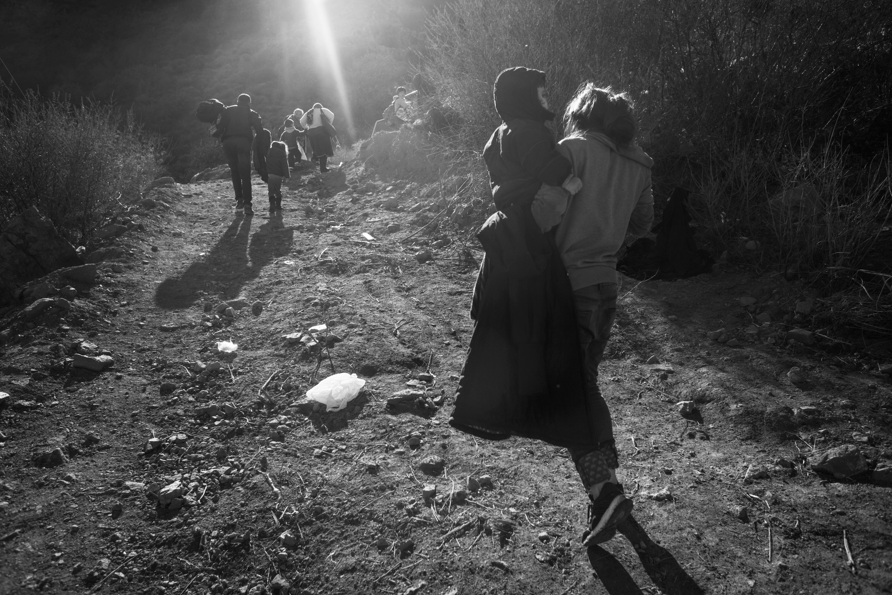Refugees from Afghanistan and Syria that arrived in boats on the shores of Lesbos near Molivos walk out from the beach to a transit camp, on 04 November, 2015. Lesbos, the Greek vacation island in the Aegean Sea between Turkey and Greece, faces massive re