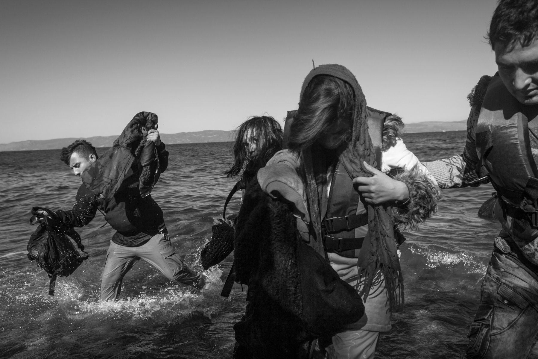 Refugees from Afghanistan and Syria disembark from inflatable boats on the shores of Lesbos near Skala Skamnias, Greece on 02 November, 2015. Lesbos, the Greek vacation island in the Aegean Sea between Turkey and Greece, faces massive refugee flows from t