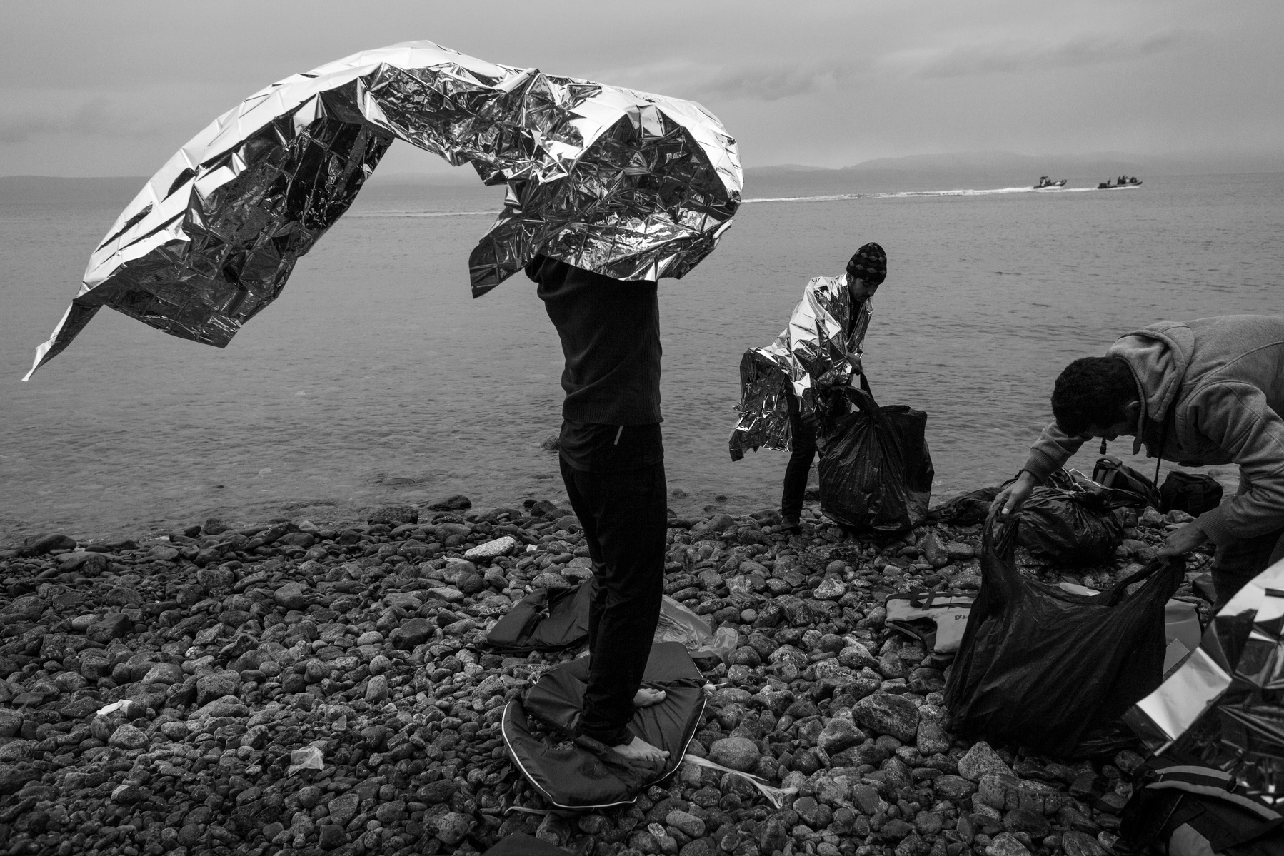 Before heading to a transit camp, refugees from Afghanistan check their belonging after they landed by rubber boats on the shores of Lesbos near Skala Sikaminias, Greece on 02 January, 2016. Lesbos, the Greek vacation island in the Aegean Sea between Turk