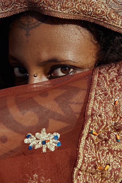 Gabrielle Tesfaye with Bryan Michael Ham Photography. Portrait of the artist, photographed on Uluwatu beach in Bali, Indonesia. Close up of the beautiful eyes of Gabrielle, while wearing traditional fabrics of the Tigray culture. 