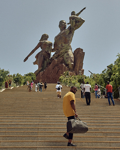Steven DK Brown with Bryan Michael Ham Photography, in Dakar Senegal. Walking the steps of the Renaissance Monument in Dakar.