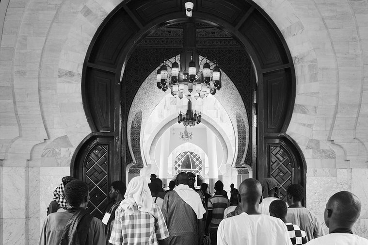The great mosque of Touba. Walking through the main entrance by Bryan Ham Photography