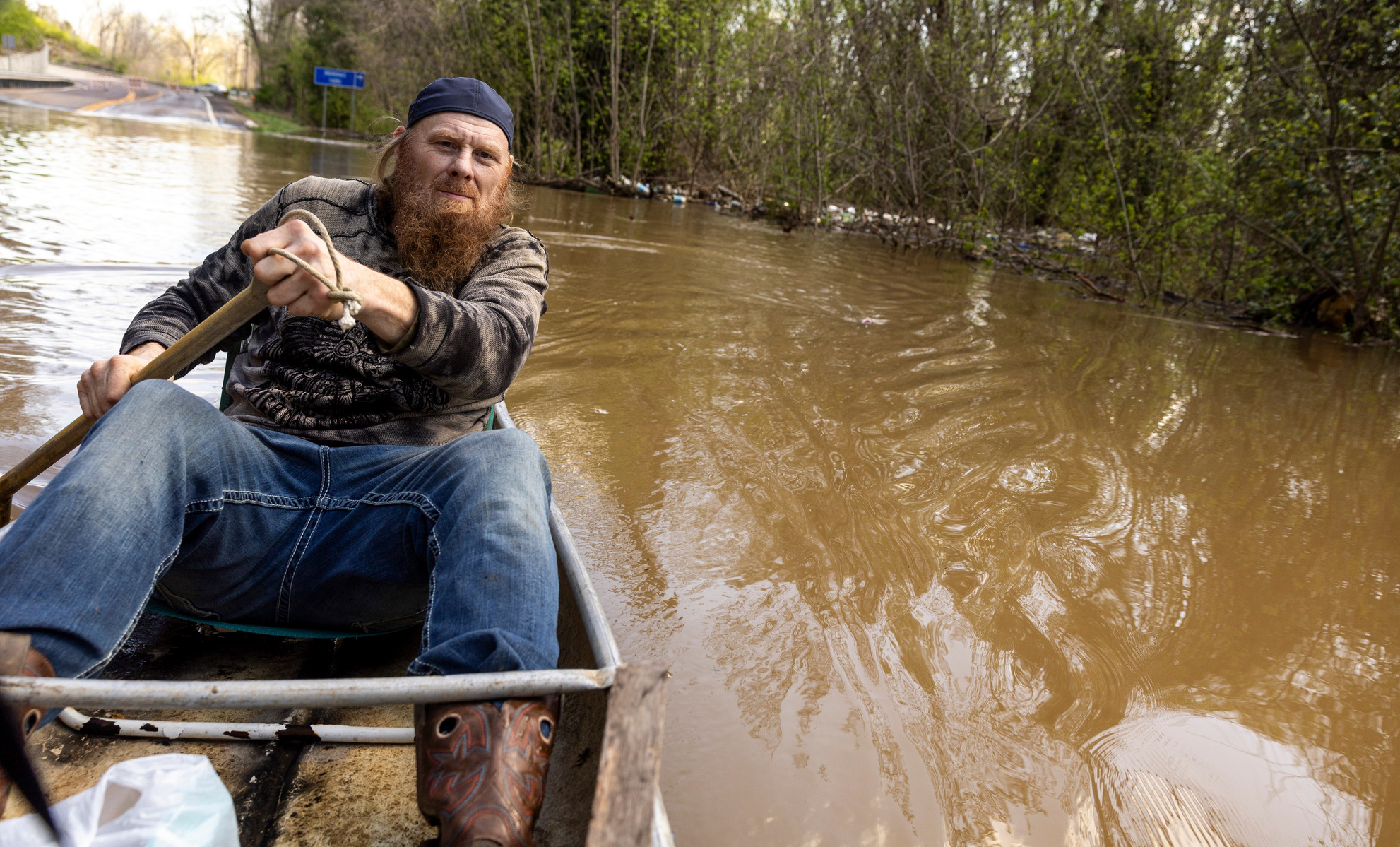 Chip Huskey paddles through floodwaters from the Big River to check on his cabin along State Road W in Jefferson County on Tuesday, April 8, 2025. The Meramec River topped out at 32.4 feet around 5 a.m. Tuesday after heavy rains over the weekend.