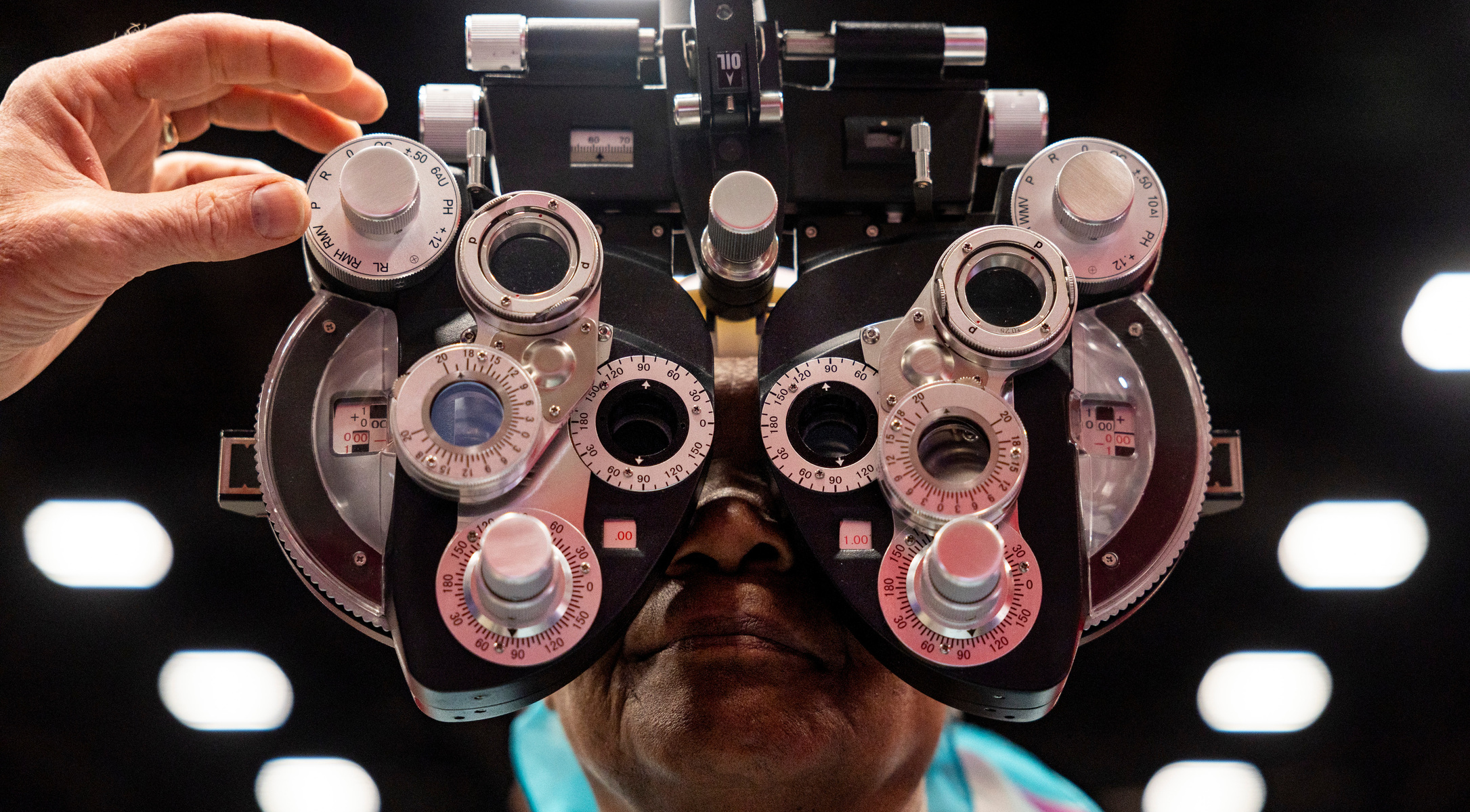 Alice Mureithi, from Kenya but living in St. Louis, gets an eye exam from Dr. Daniel Beckner, of Oregon, during a free health care clinic at the America's Center Convention Complex in downtown St. Louis on Tuesday, May 6, 2025. Pathway to Health, a humani