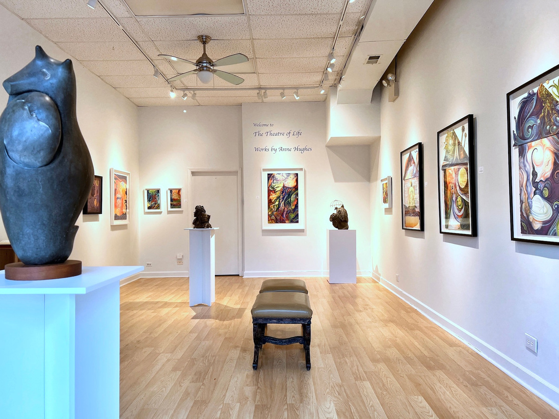 Sculptures and paintings in a gallery room.
