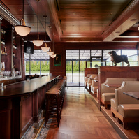 Restaurant Photography showing off bar and booths encased by rich wood surfaces. Photographed in Saint Louis, Missouri