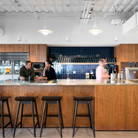 Commercial Architecture Photography of a WeWork Space, located in St. Louis, Missouri.  Members interacting around a coffee bar.