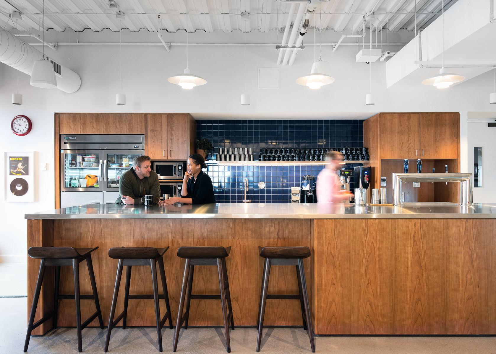 Commercial Architecture Photography of a WeWork Space, located in St. Louis, Missouri.  Members interacting around a coffee bar.