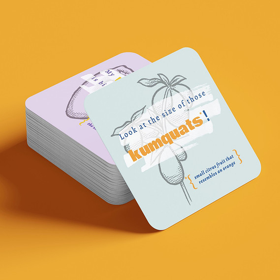 A stack of coasters with illustrations on them. A blue coaster is set up against the stack and shows a drawing of kumquats. Text overlays the drawing that says 