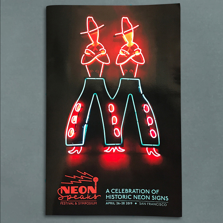 Cover of the Neon Speaks festival program with a neon sign of twin cowboys and the festival logo.