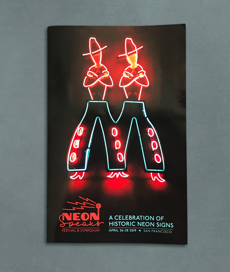 Cover of the Neon Speaks festival program with a neon sign of twin cowboys and the festival logo.