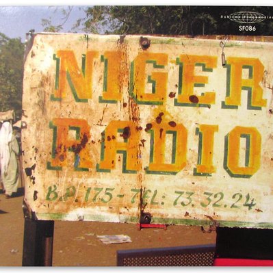 CD cover art for "Radio Niger" featuring an old rusty sign with hand painted lettering with shadow that says "Niger Radio" in yellow and green.