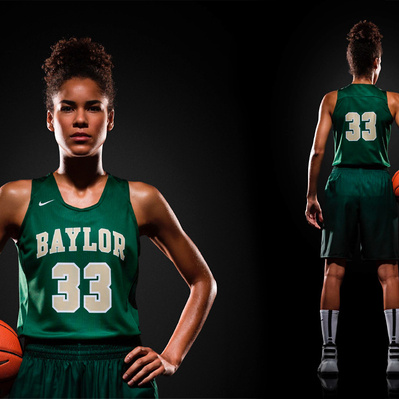 A female basketball player modeling a dark green jersey bearing the number 33 in Nike's Full Block outline font numerals.