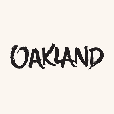 Black and white hand drawn lettering of the phrase "OAKLAND" in black and white casual capitals script.