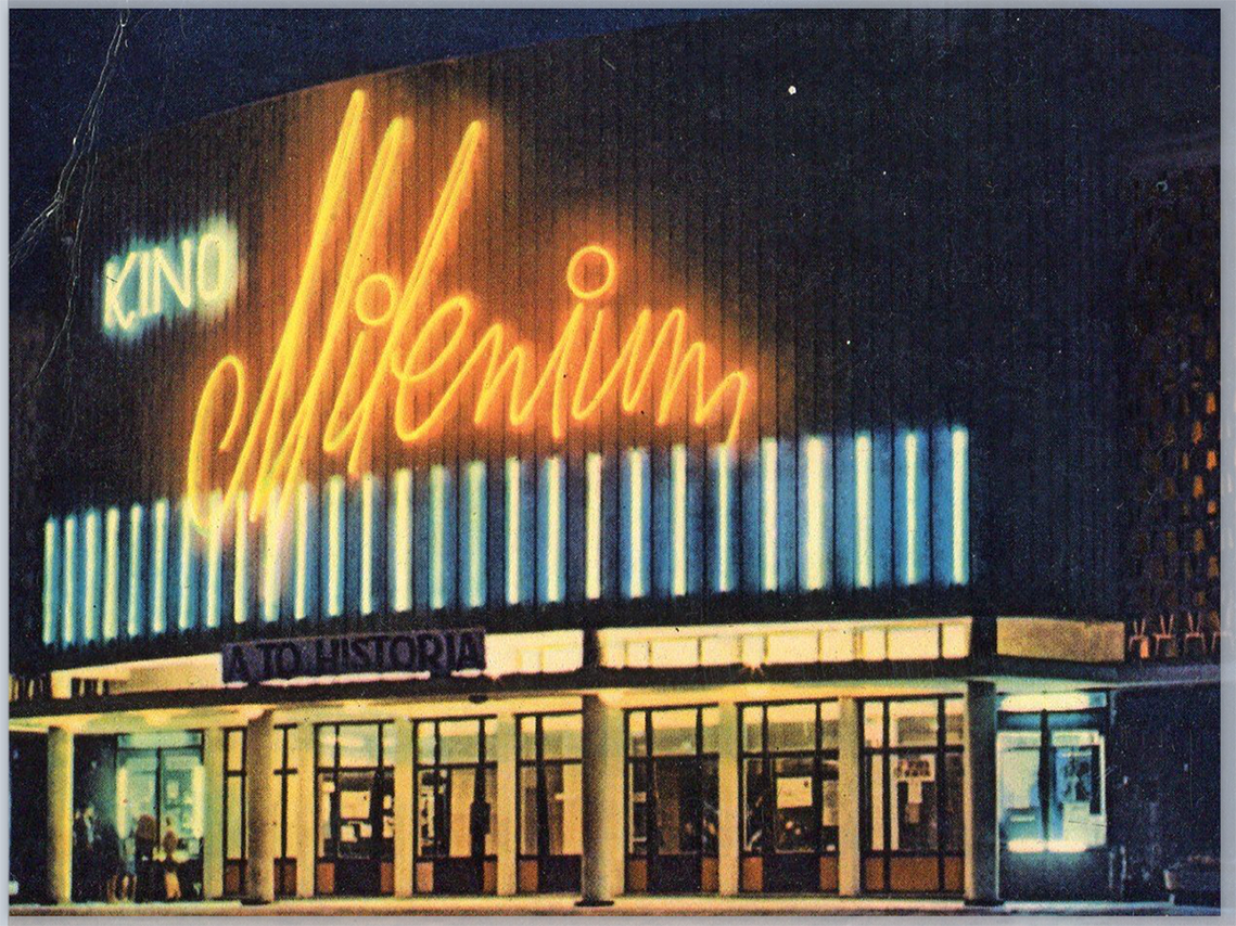 An aged night photograph of the entrance and neon sign at the 
