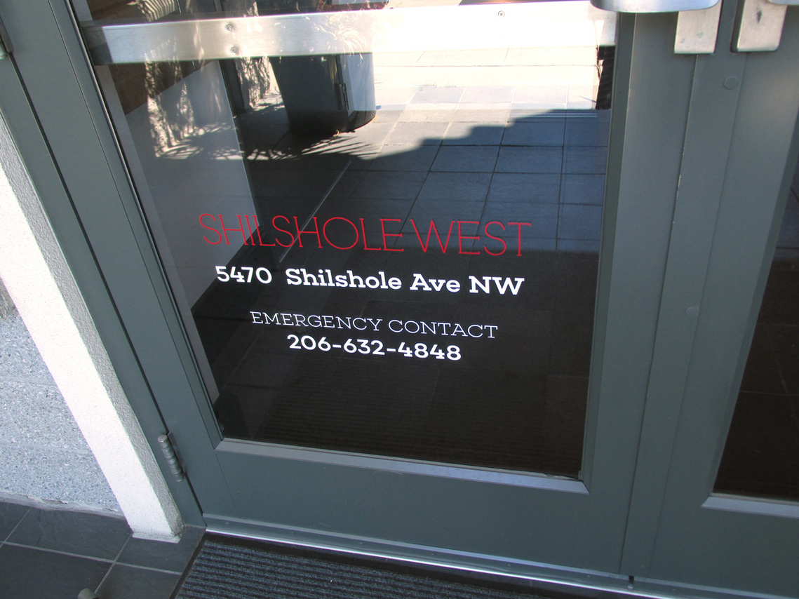 Shilshole West address and phone number on the front door of the Ballard Seattle office building.