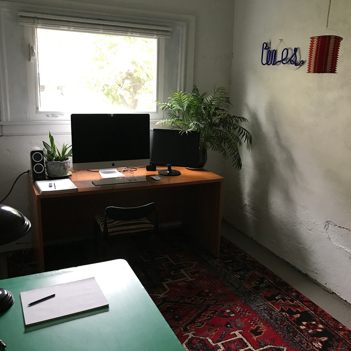 Studio of Kate Widdows, letterer and designer, including a desk, computer, and drawing table.
