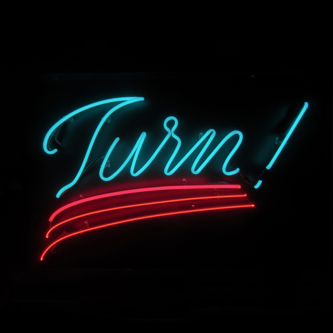 A lit neon sign of the word 