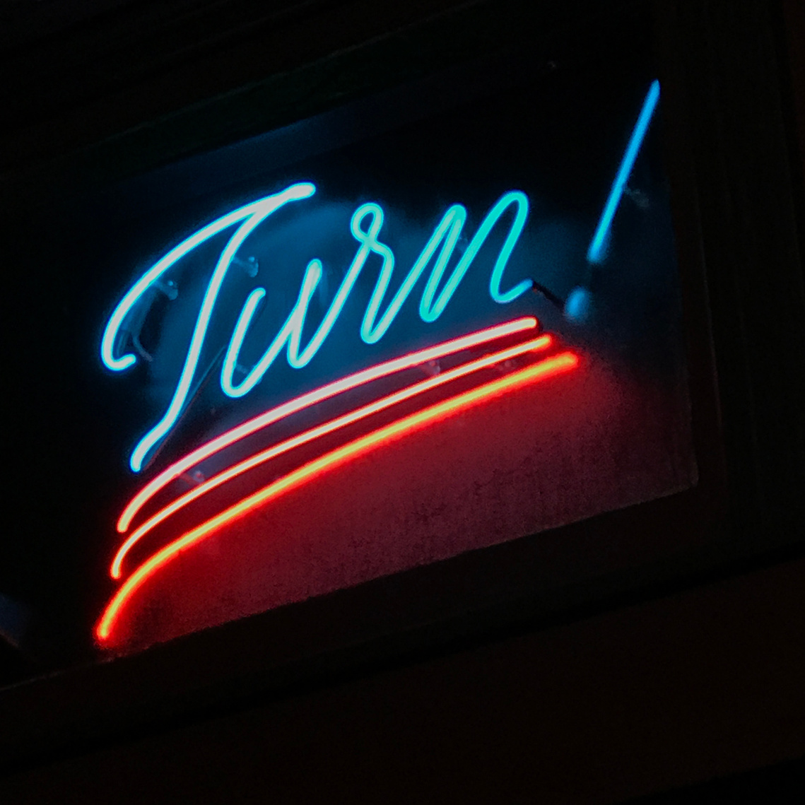 A lit neon sign of the word 