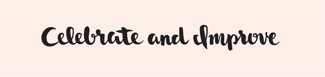 The phrase “Celebrate and Improve” hand lettered with a brush in black ink in a heavy upright script, on a pale peach background.