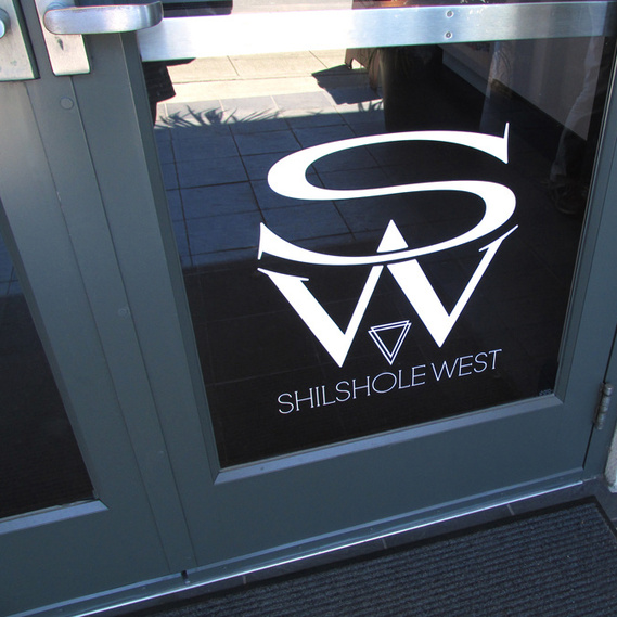SW Shilshole West logo on the front door of the Ballard Seattle office building.