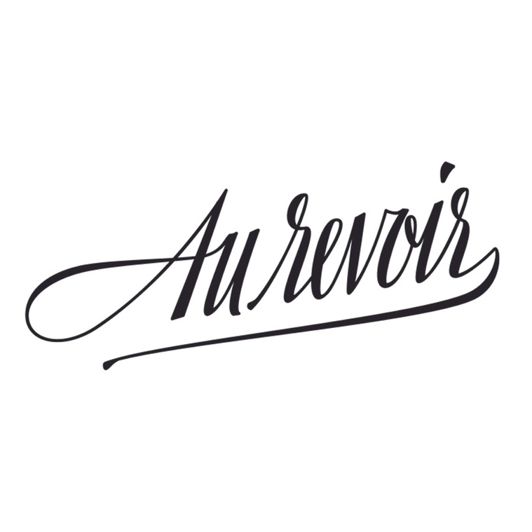 The French phrase “Au Revoir” (which means “goodbye” in English) neatly custom lettered in a compressed italic script, in the style of a calligraphy nib pen, in black ink.