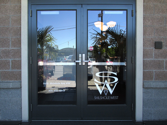 SW Shilshole West logo on the wall of the lobby of the Ballard Seattle office building.