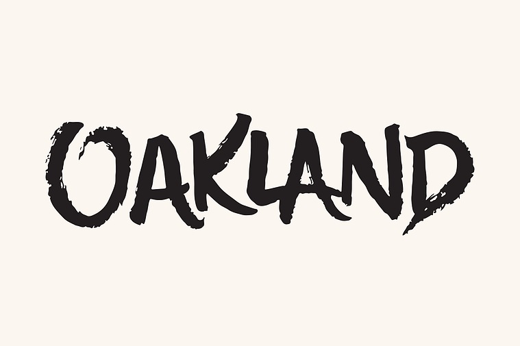 The word “OAKLAND” hand lettered with an inky brush in dynamic capital letters.