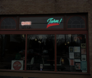 Digital mockup of the north exterior wall of the Turn! Turn! Turn! at night, including the neon sign design for 