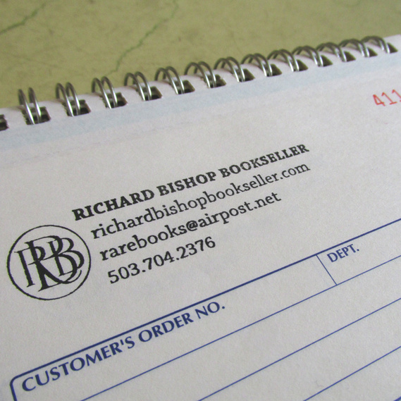 Rubber stamp on sales slip for Richard Bishop bookseller black text and a monogram design of 