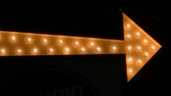 Arrow made of light bulbs.
