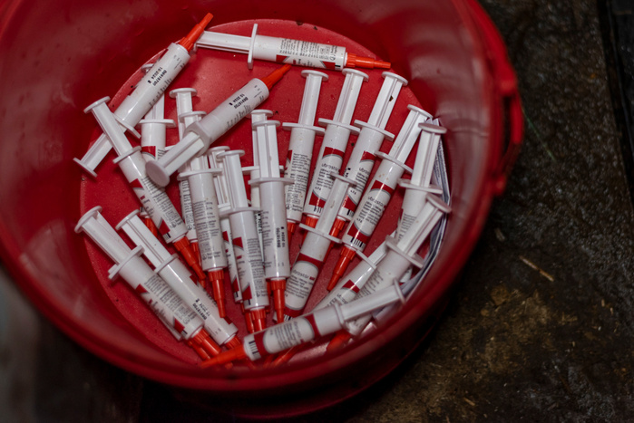 Antibiotics for the treatment of mastitis - a painful inflammation of the mammary glands, which affects a third of all UK cows used for dairy - and the prevention of bacterial infections of cow udders lie discarded in a bucket at an intensive dairy farm.