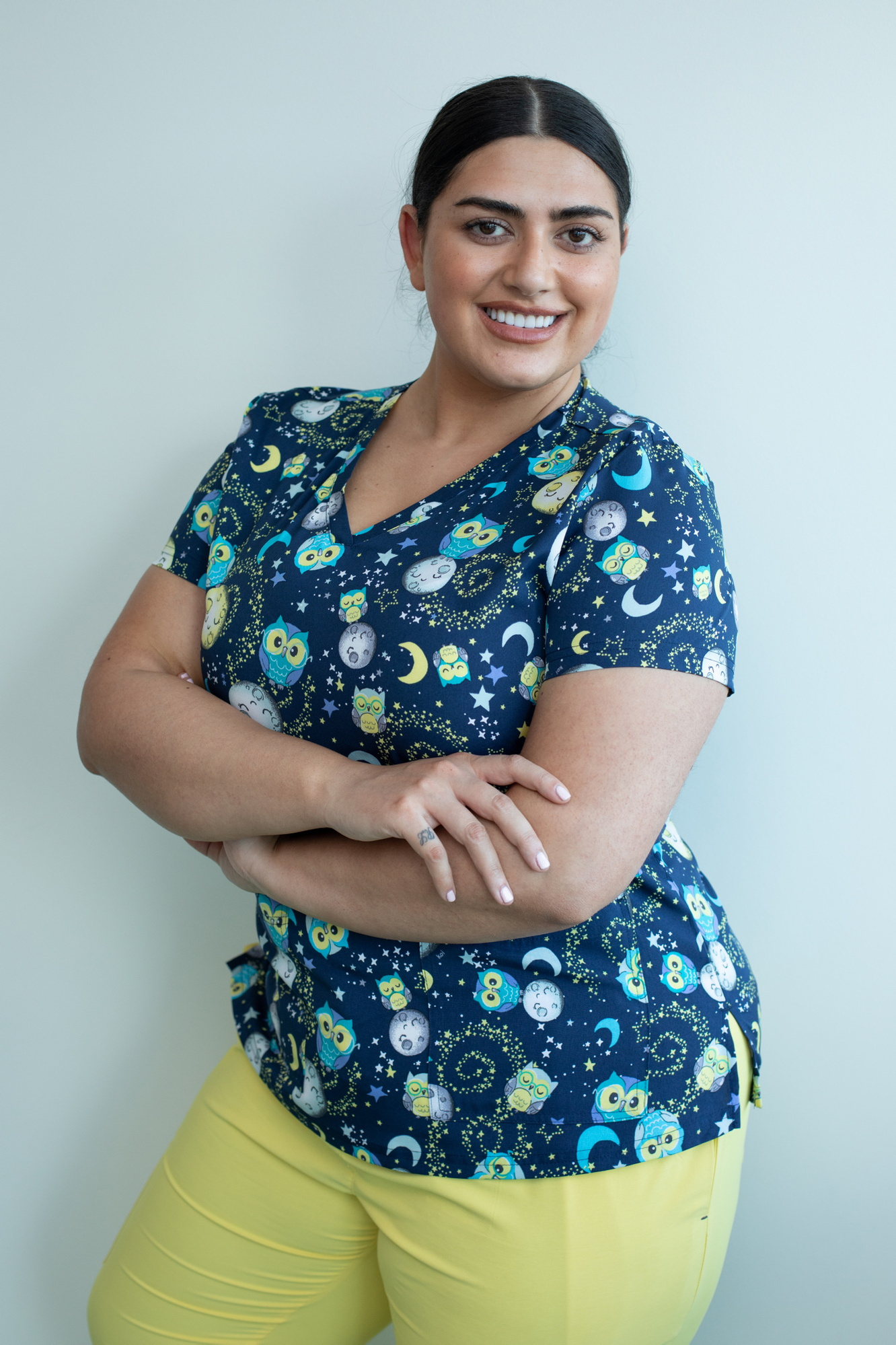 Happythreads Commercial Clothing Brand for Healthcare Professionals.  Lifestyle Photoshoot, model wears yellow scrubs and print top. Professional photographer Dublin 