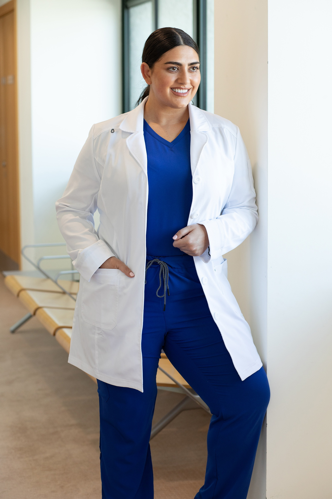 Happythreads Commercial Clothing Brand for Healthcare Professionals.  Lifestyle Photoshoot, model wears blue scrubs and white lab coat. Professional photographer Dublin 