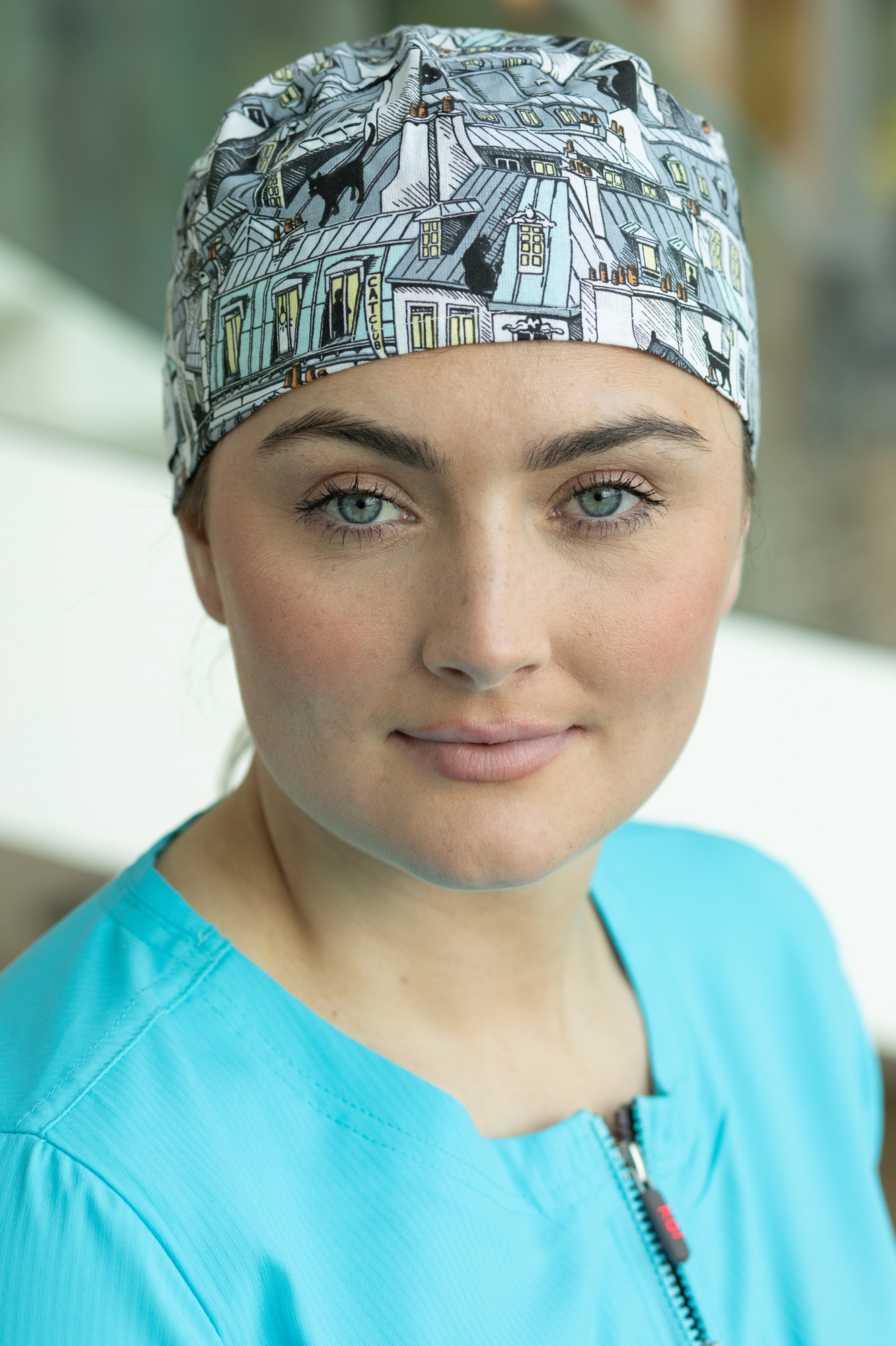 Happythreads Commercial Clothing Brand for Healthcare Professionals.  Lifestyle Photoshoot model wears blue scrubs and headcover. Professional photographer Dublin 