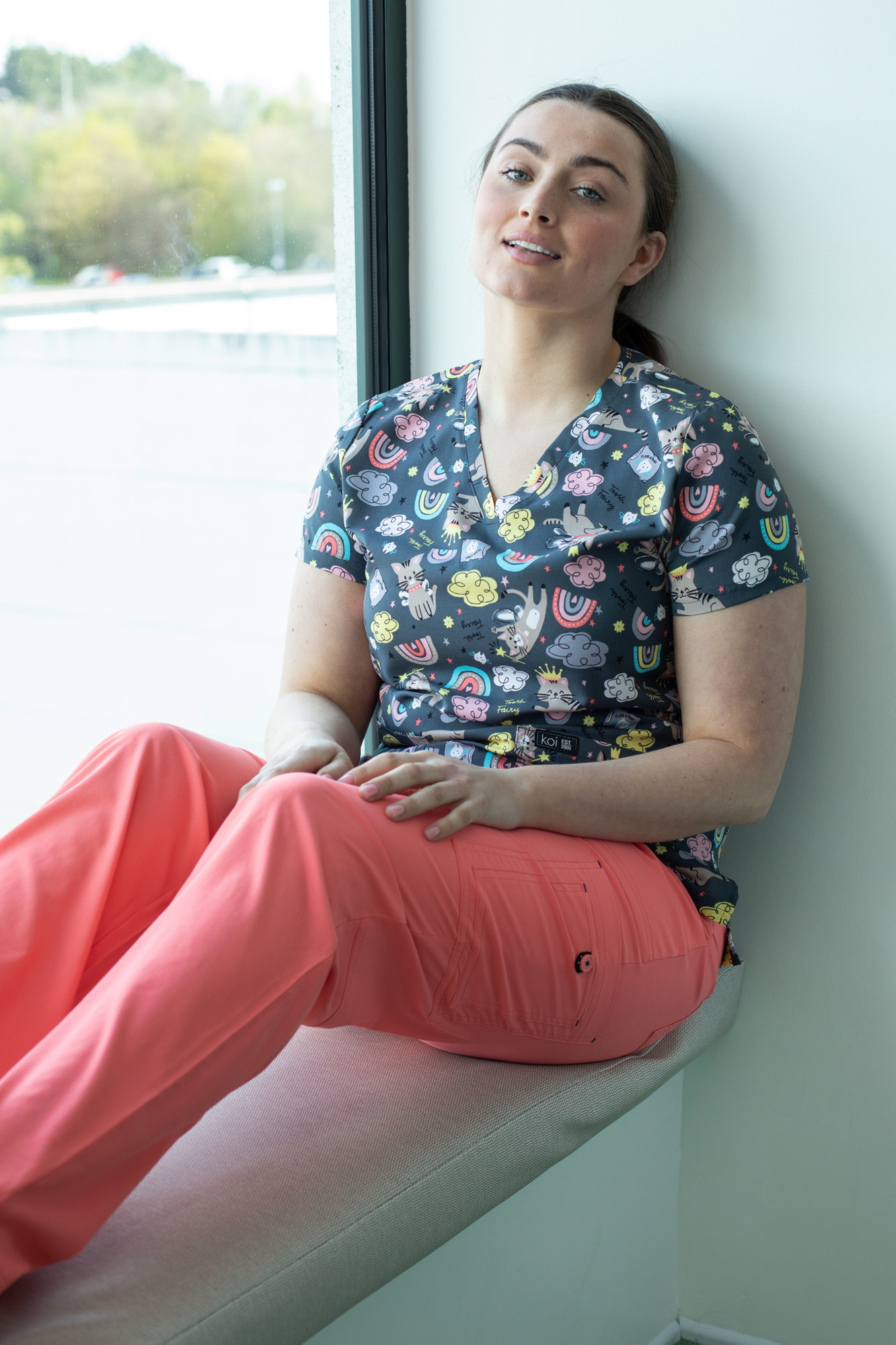 Happythreads Commercial Clothing Brand for Healthcare Professionals.  Lifestyle Photoshoot, model wears pink scrubs and print top. Professional photographer Dublin 