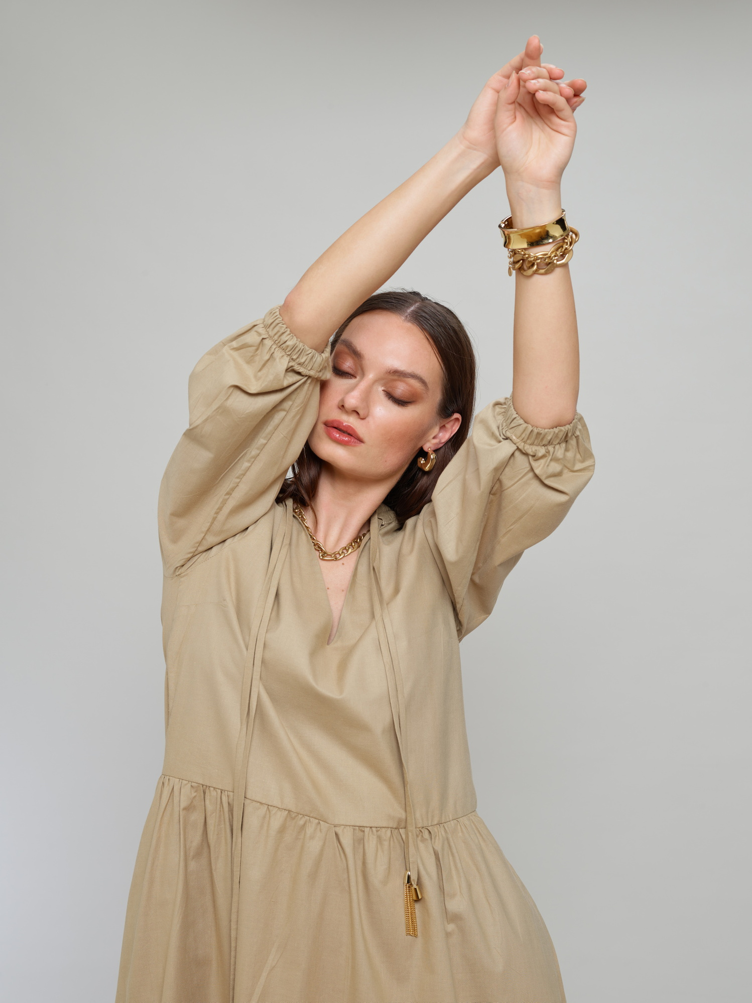 Model wears a beige dress for Amilli Clothing Studio Fashion shoot Spring/Summer 2023 collection in a professional commercial photography studio in Dublin