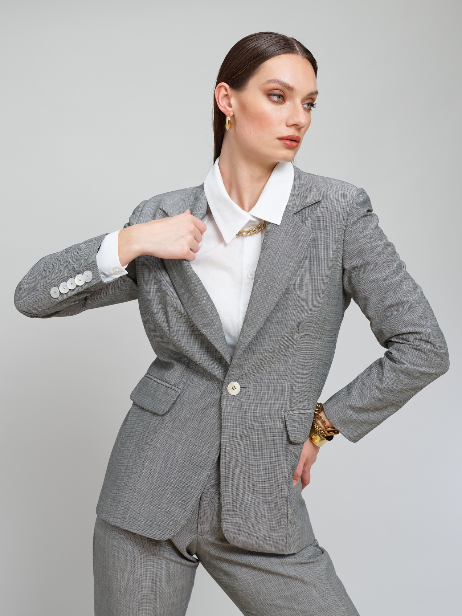 Model wears a grey suit for Amilli Clothing Studio Fashion shoot Spring/Summer 2023 collection in a professional commercial photography studio in Dublin