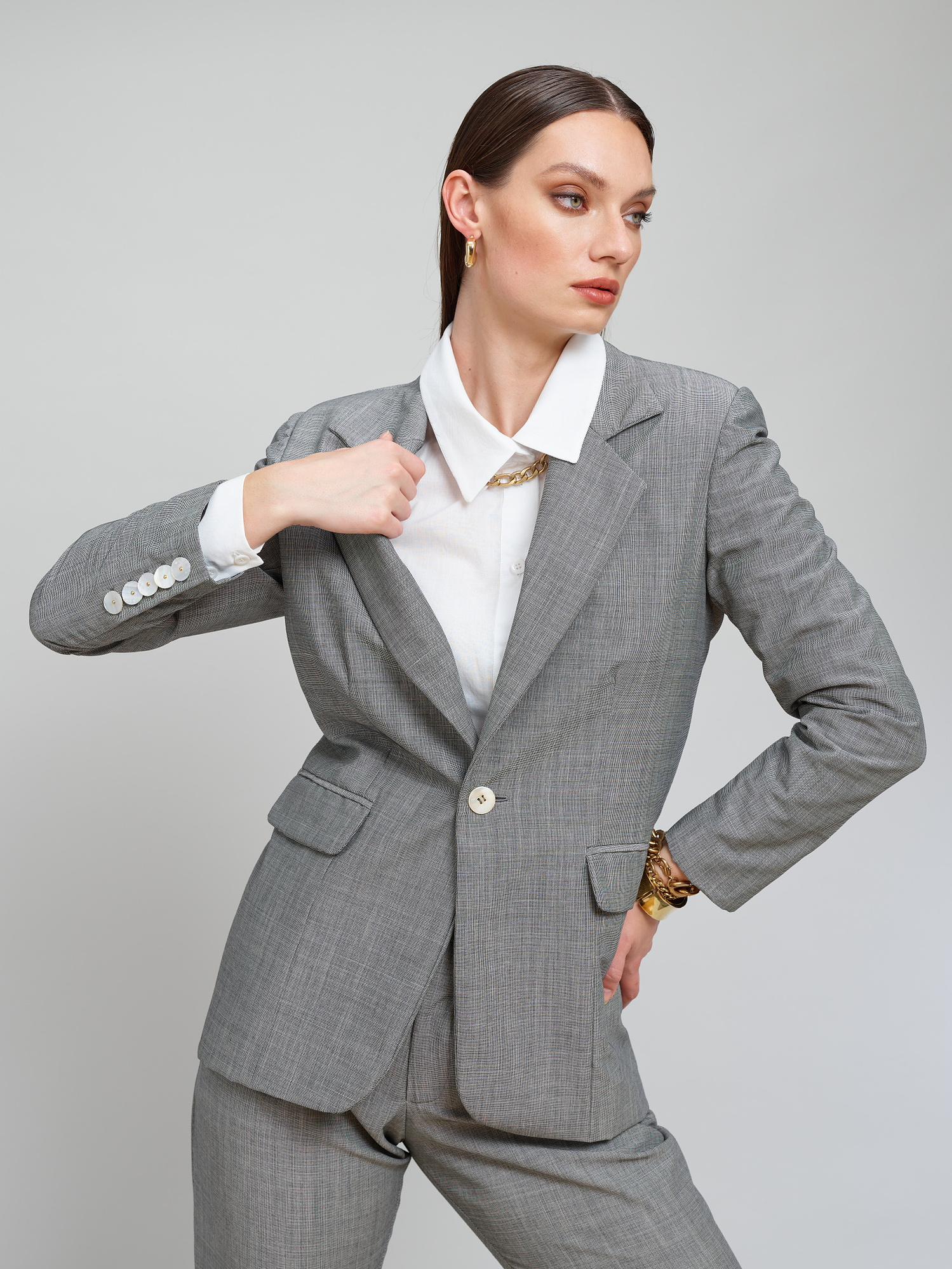 Model wears a grey suit for Amilli Clothing Studio Fashion shoot Spring/Summer 2023 collection in a professional commercial photography studio in Dublin