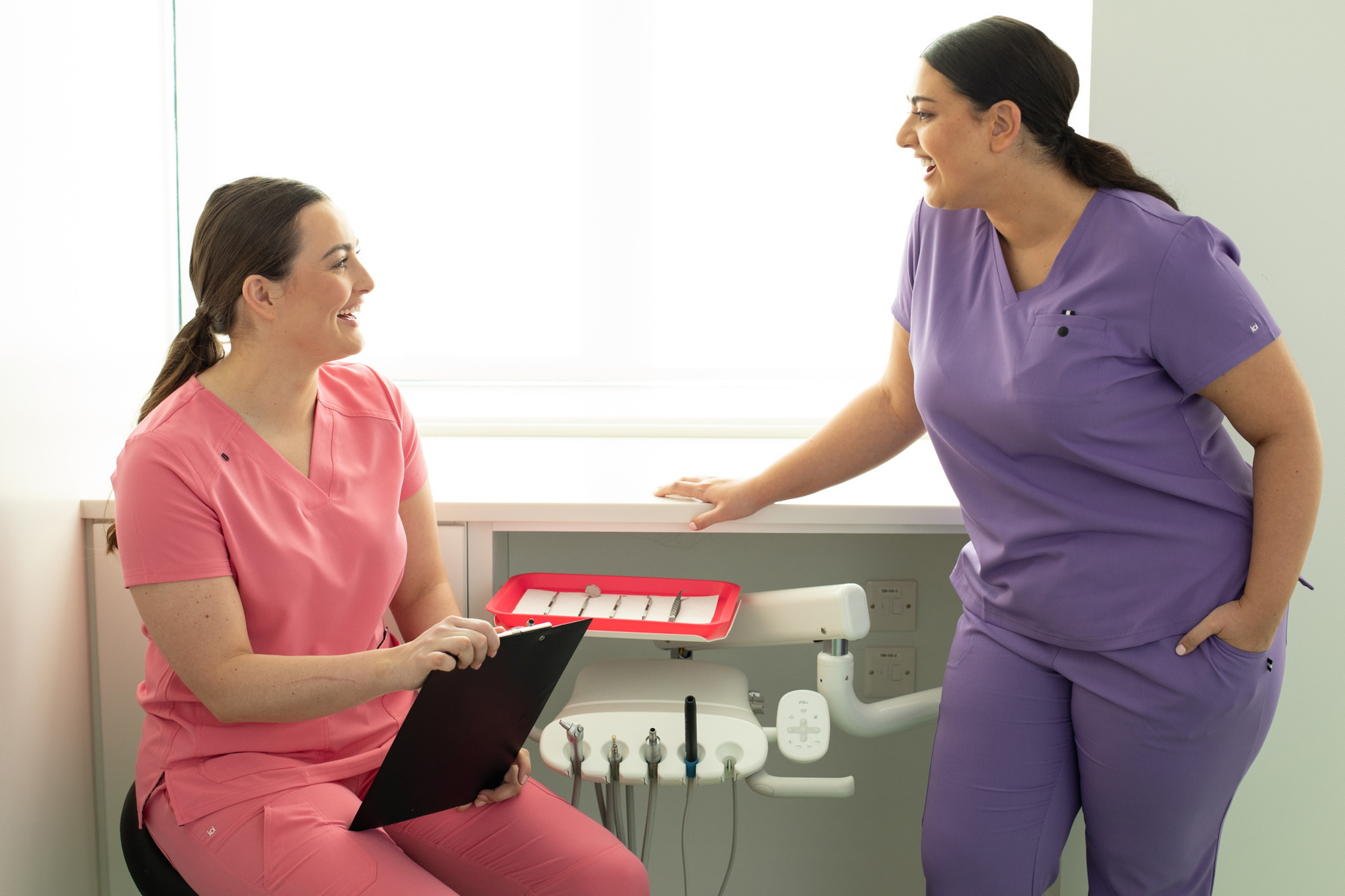 Happythreads Commercial Clothing Brand for Healthcare Professionals.  Lifestyle Photoshoot two models wear pink and purple scrubs. Professional photographer Dublin 