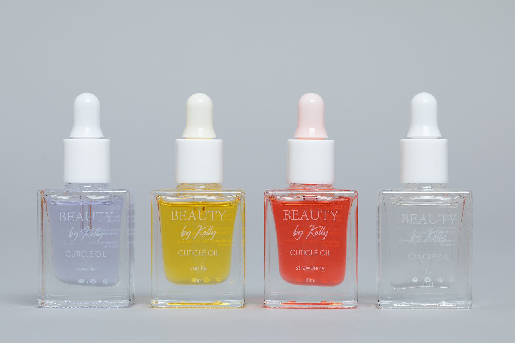 Commercial Product photography studio cut out pack shot of 4 bottles of coloured cuticle oil www.bryanjamesbrophy.com