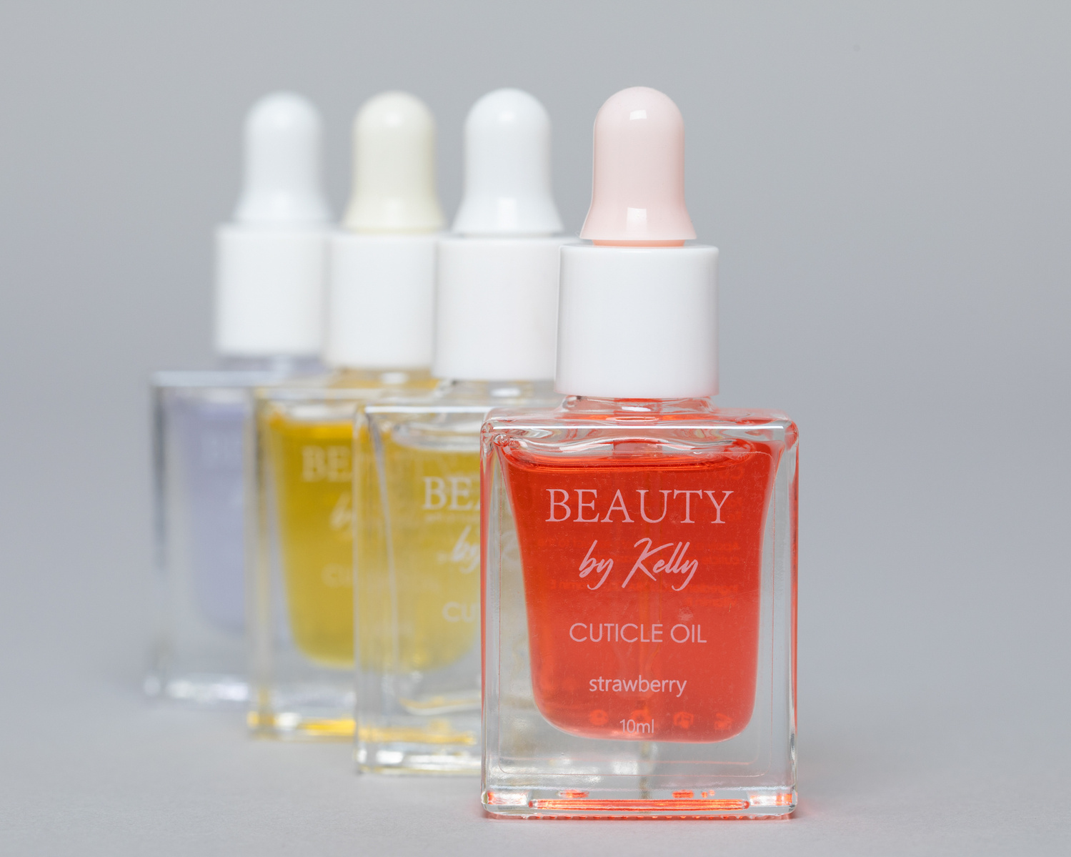 Commercial Product photography studio pack shot of 4 bottles of coloured cuticle oil www.bryanjamesbrophy.com