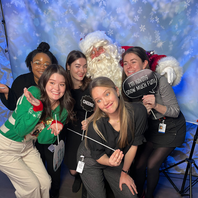 A group of diverse individuals posing happily with Santa Clause at a photo booth session
http://www.annanproductions.com/
