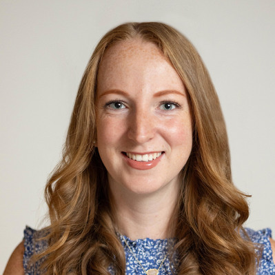 A Corporate headshot of a smiling woman with brown medium-length hair wearing a blue and white floral printed sleeveless top at the Astho Conference 2023 in Crystal City, Virginia.
http://www.annanproductions.com/