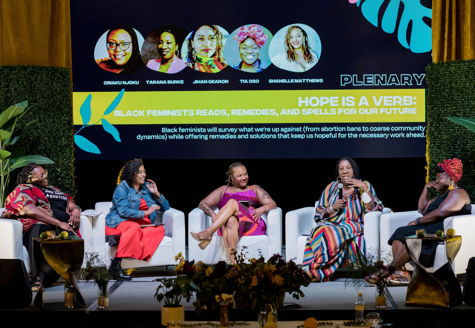 A five-person panel composed of beautiful black women named Oriaku Njoku, Tarana Burke, Jeahan Gearon, Tia Oso, and Shannelle Matthews speaking at the Black Feminist Future event.