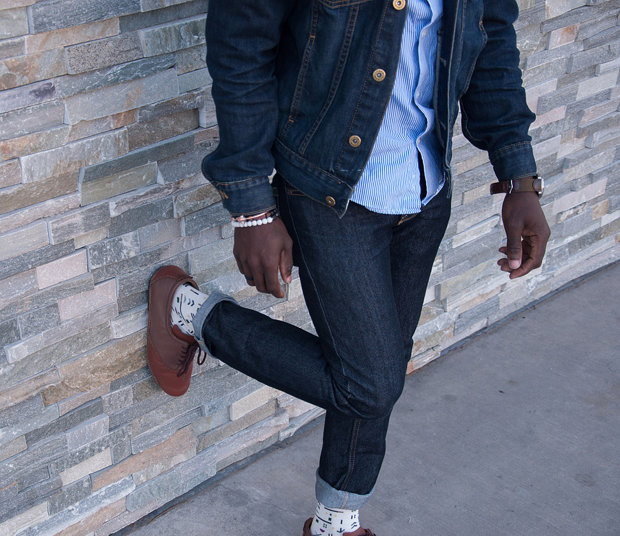 Custom sock designs on model leaning against wall