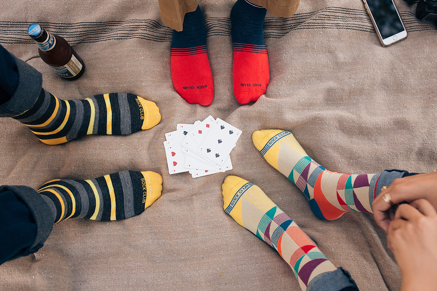Custom sock designs modeled on friends playing cards
