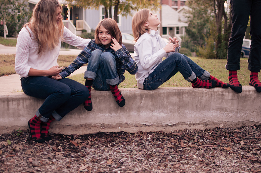 Custom sock designs modeled on family in backyard
