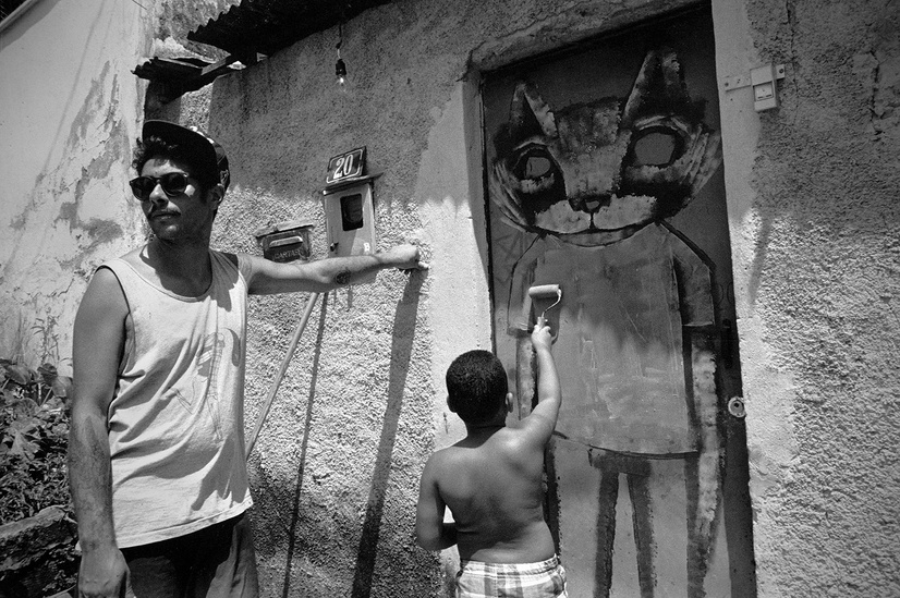 Thiago Goms does graffiti and street art at Meeting of the Favelas MOF in Vila Operaria a favela in Rio De Janeiro, Brazil photo by Jordan Starr