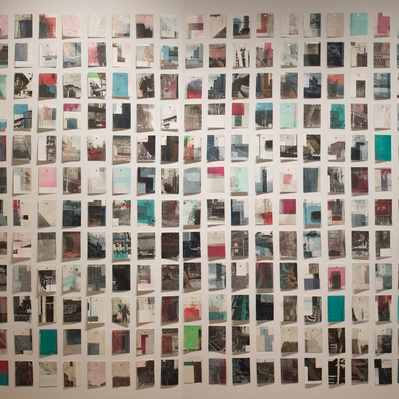 A large grid of colourful prints of architectural details pinned to a white wall.